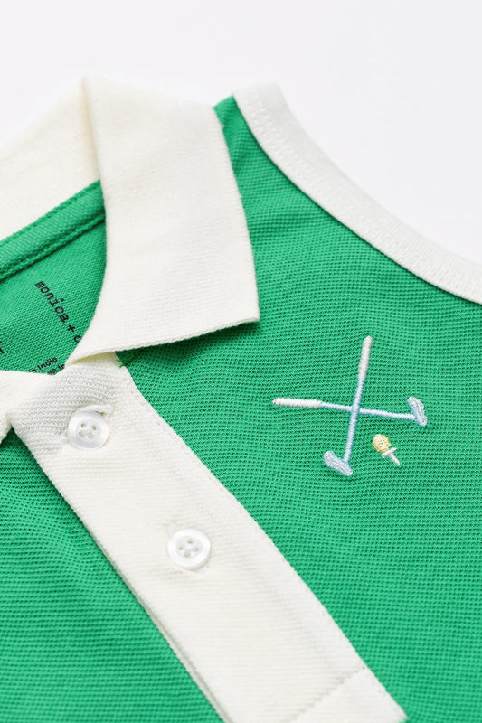 Detail shot of girls golf dress embroidery in top left pocket area with crossed golf clubs with a ball and tee.