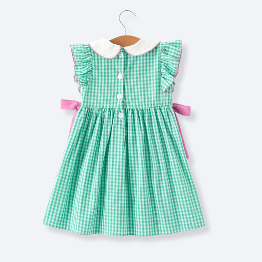 Back view of girls green gingham smocked dress with button closure and pink bows