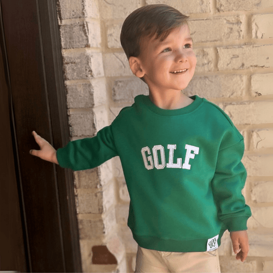 boy wearing green kids golf sweatshirt