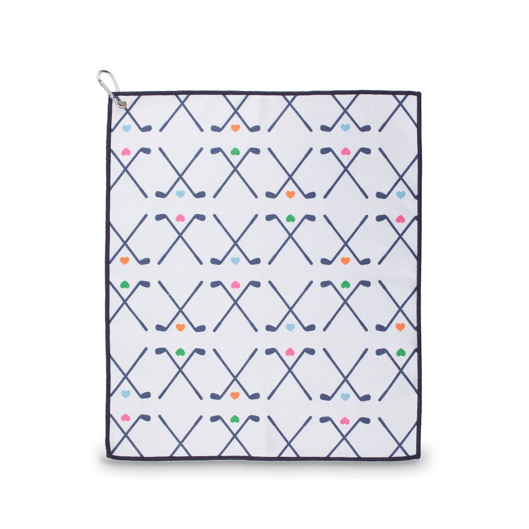 White microfiber golf towel with navy trim, crossed golf club pattern and colorful hearts, shown flat with attached carabiner clip.
