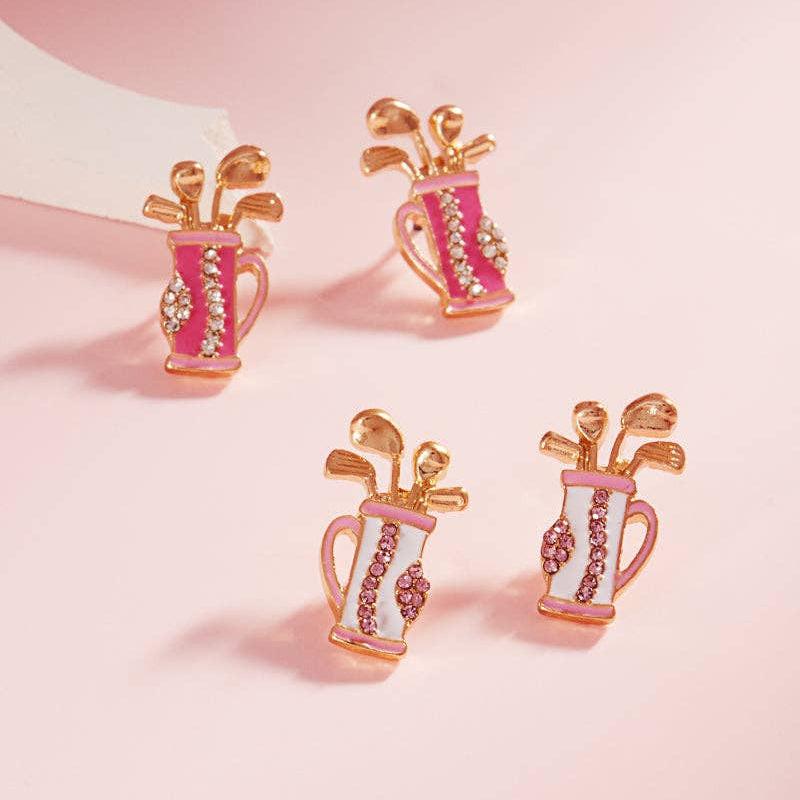 2 sets of earrings featuring golf bags. one set has white golf bags with light pink and gold details. the other set has dark pink bags with light pink and gold details.