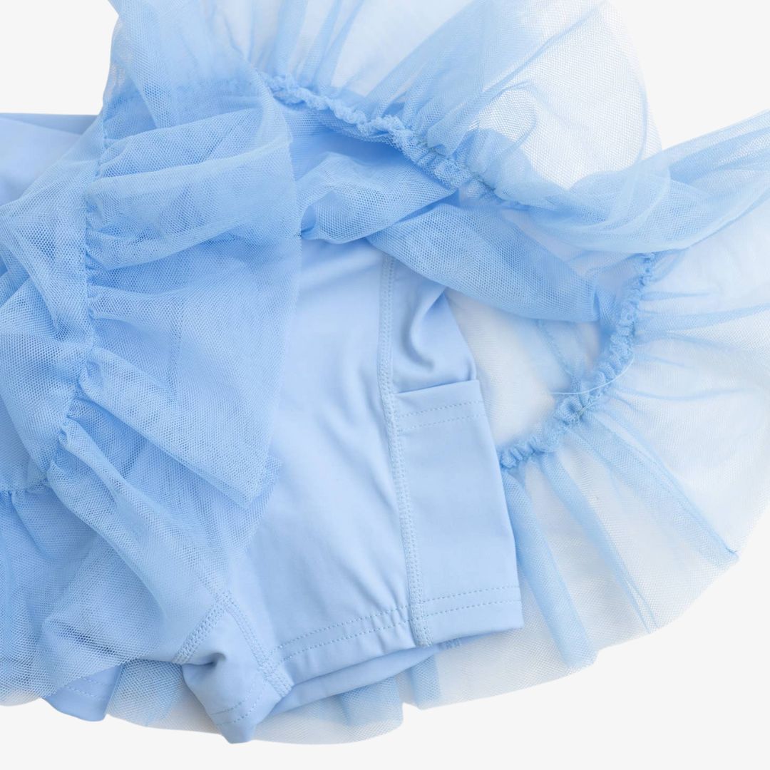 Close-up of built-in shorts with side pocket under sky blue tulle overlay on Ashlyn Athletic Skort