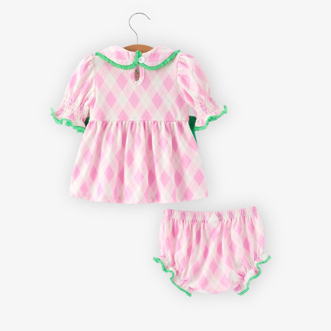 Back view of pink argyle baby top with smocked sleeves, green trim, and matching bloomer shorts