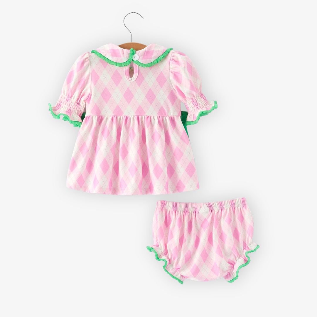 Back view of pink argyle baby top with smocked sleeves, green trim, and matching bloomer shorts