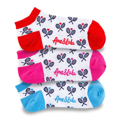 Three pairs of patterned ankle socks stacked in red, pink, and blue with tennis racket design and logo visible
