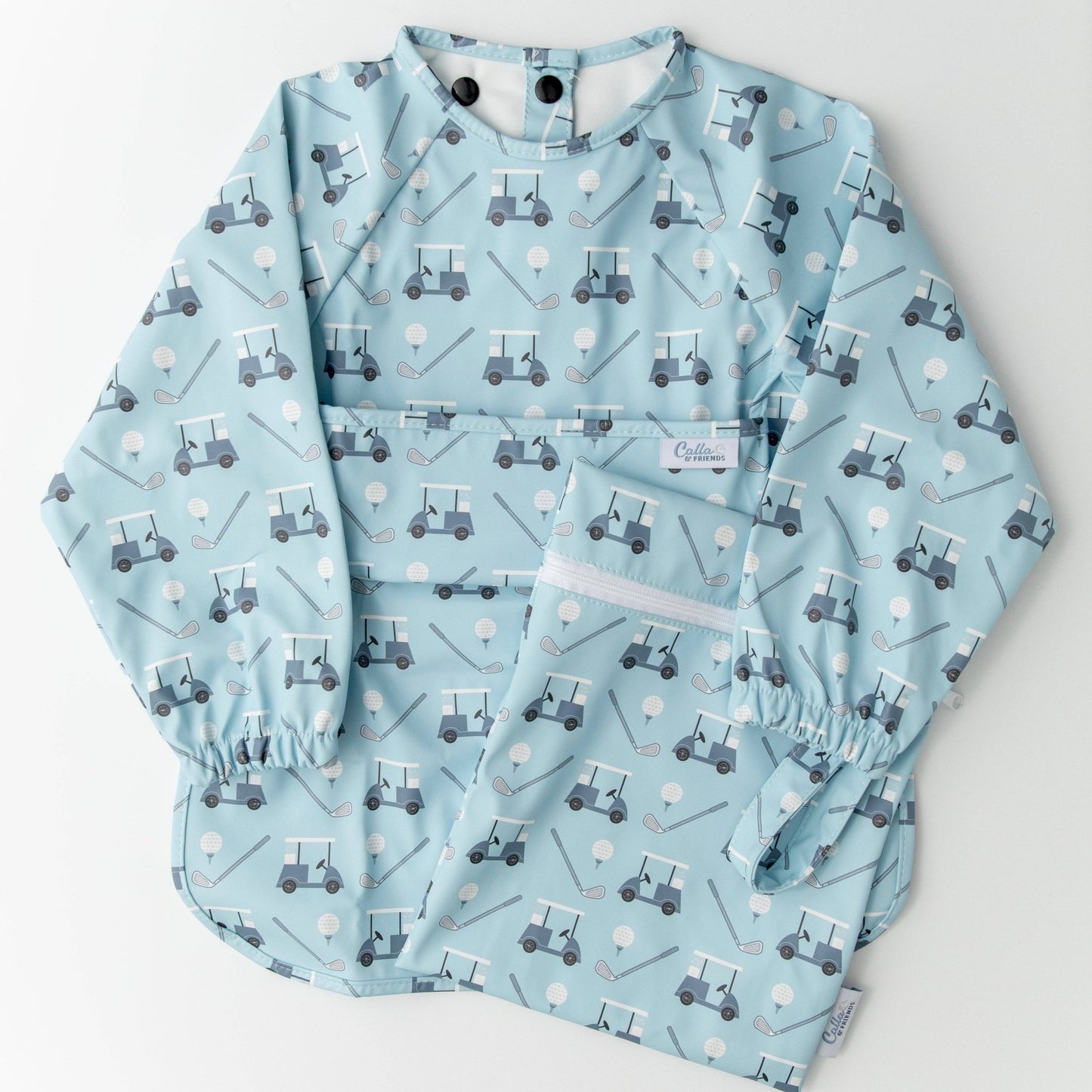 Long sleeved blue bib with golf cart pattern. Shown on a white background with wet/dry bag