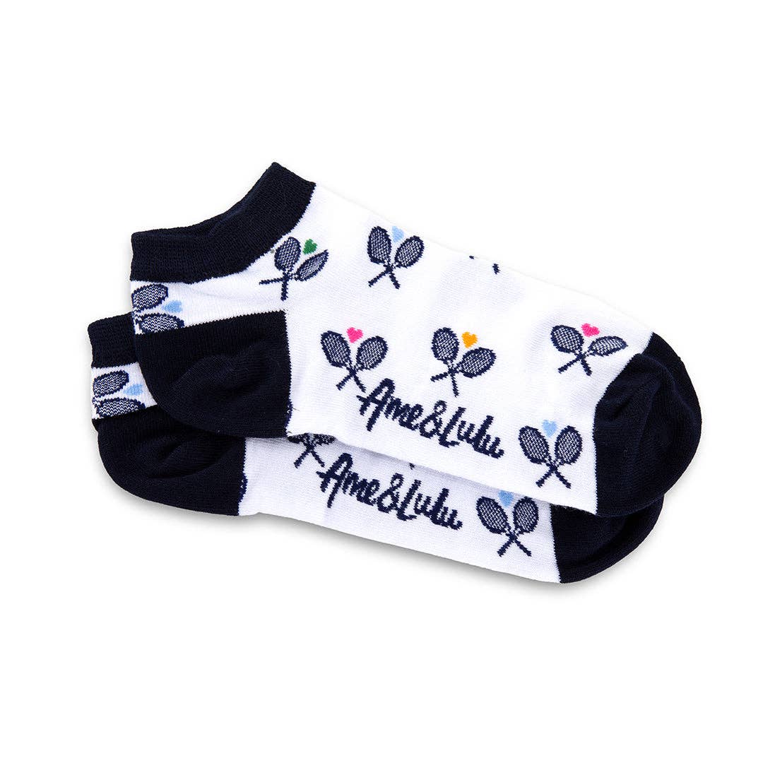 Folded pair of white ankle socks with navy heel and toe featuring repeated tennis racket design and Ame & Lulu logo