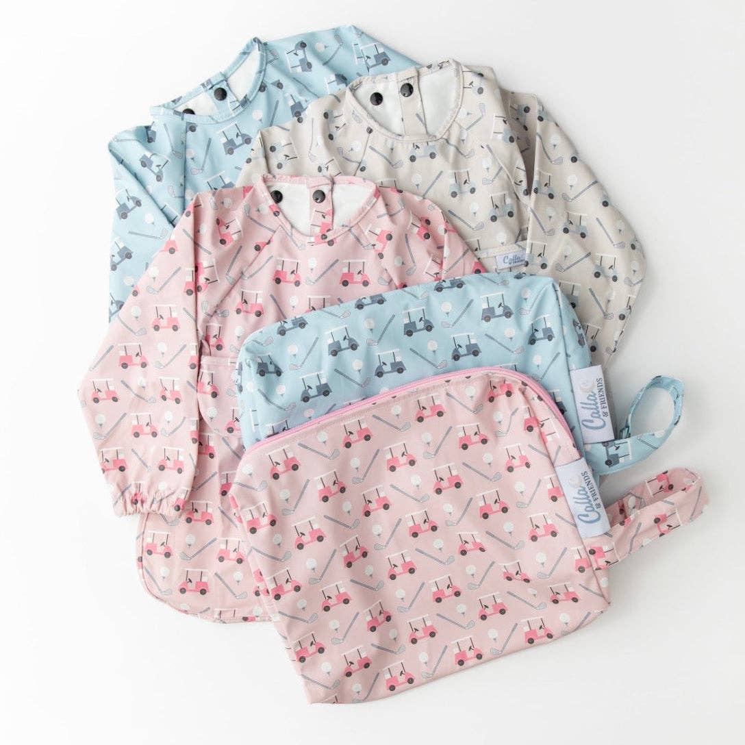 Set of baby bibs with golf cart pattern on them. Pink, blue, and grey bibs shown with wet/dry bags on a white background.