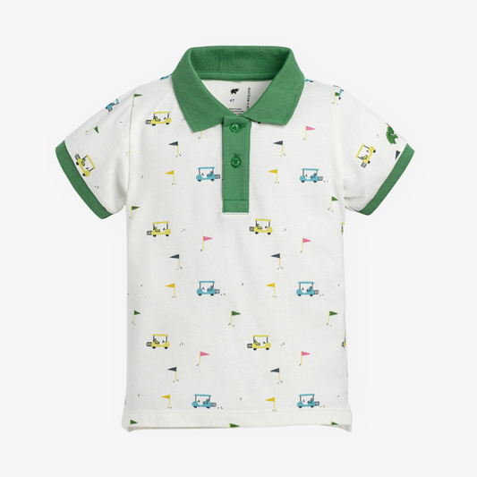 Children's polo shirt with green collar and white body featuring colorful golf patterns on a white background