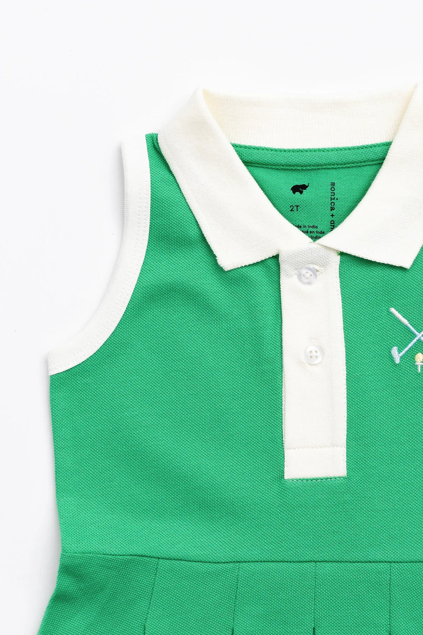 Top portion of green golf dress. Sleeveless design with white trim around arm, foldover collar, and 3 button closure.