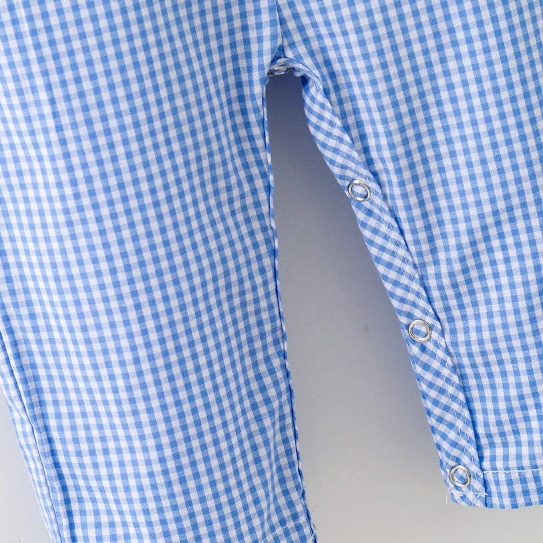 Detail of snap closure on blue plaid baby baseball romper