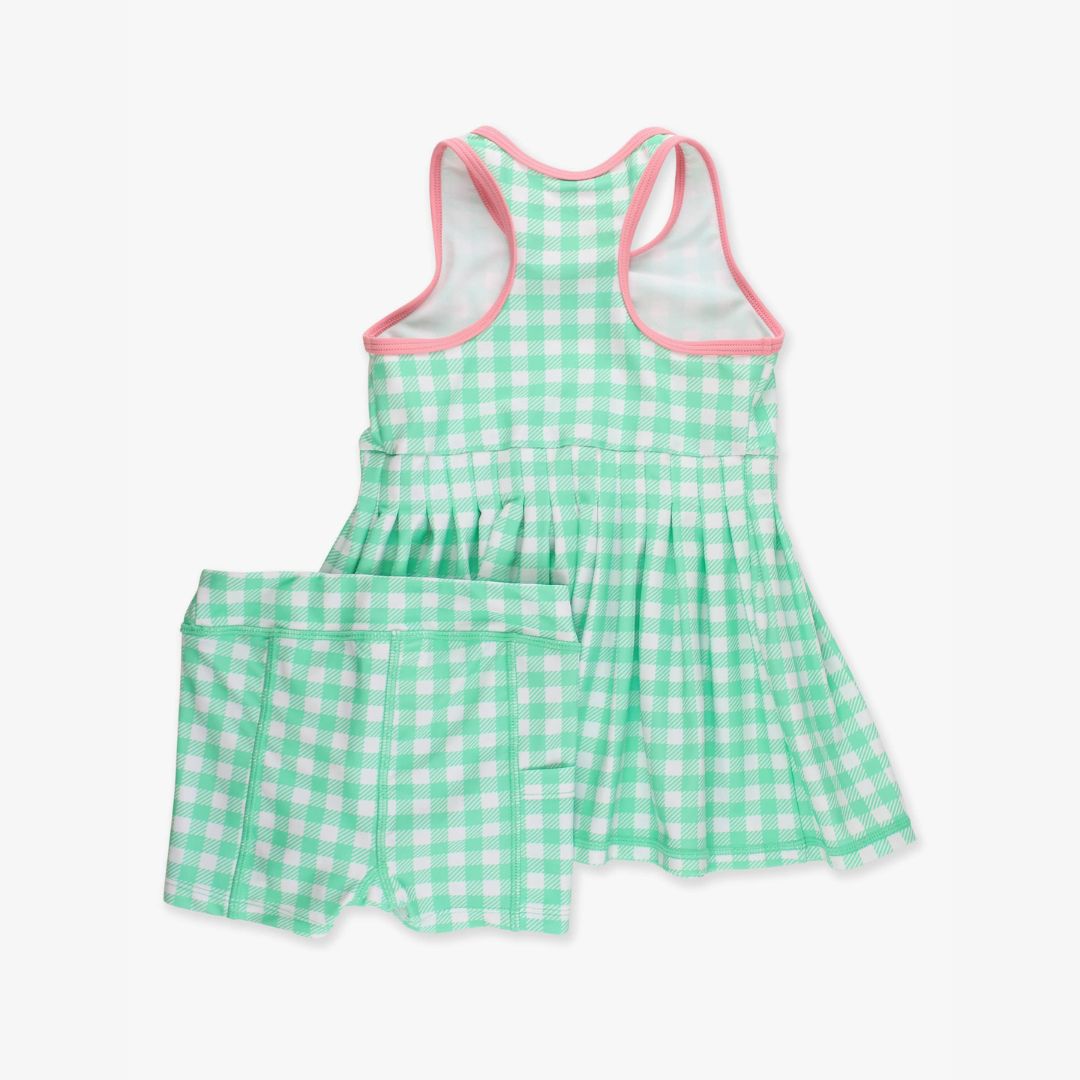 Back view of green gingham active dress with racerback tank design and pleated skirt, laid flat on white background.