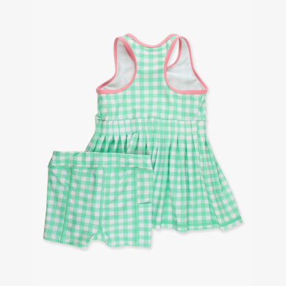 Back view of green gingham active dress with racerback tank design and pleated skirt, laid flat on white background.