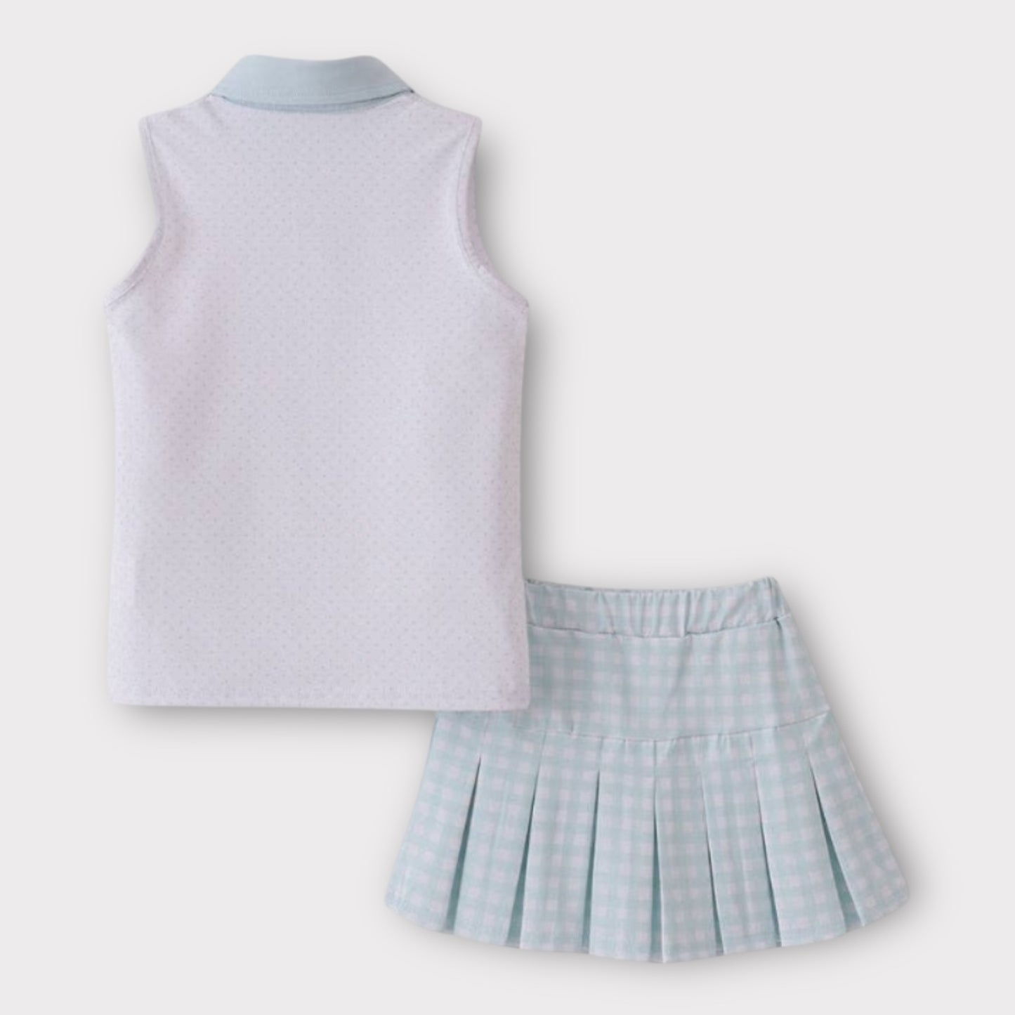 Back view of sleeveless kids golf top and mint gingham pleated skort set laid flat