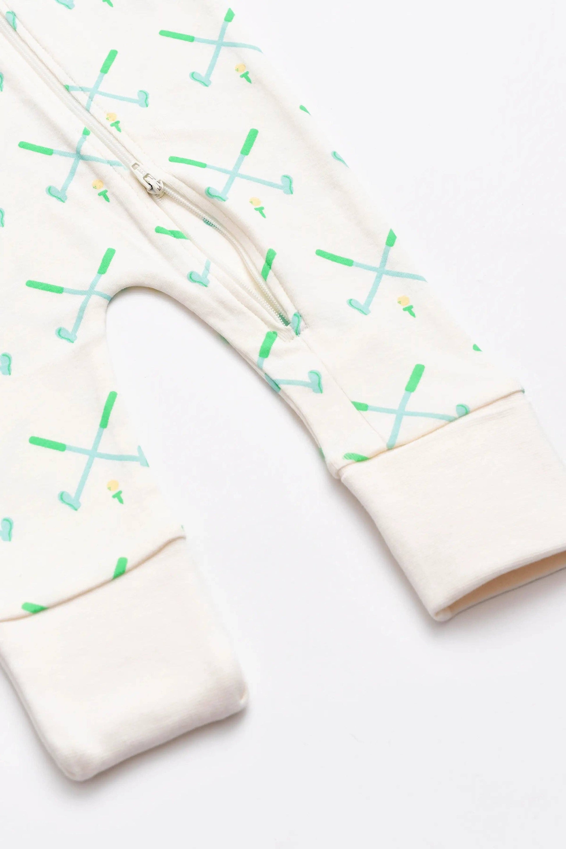 White golf themed sleeper with feet openings that can fold over to cover feet. Golf pattern with green and blue crossed golf clubs and a double zipper.