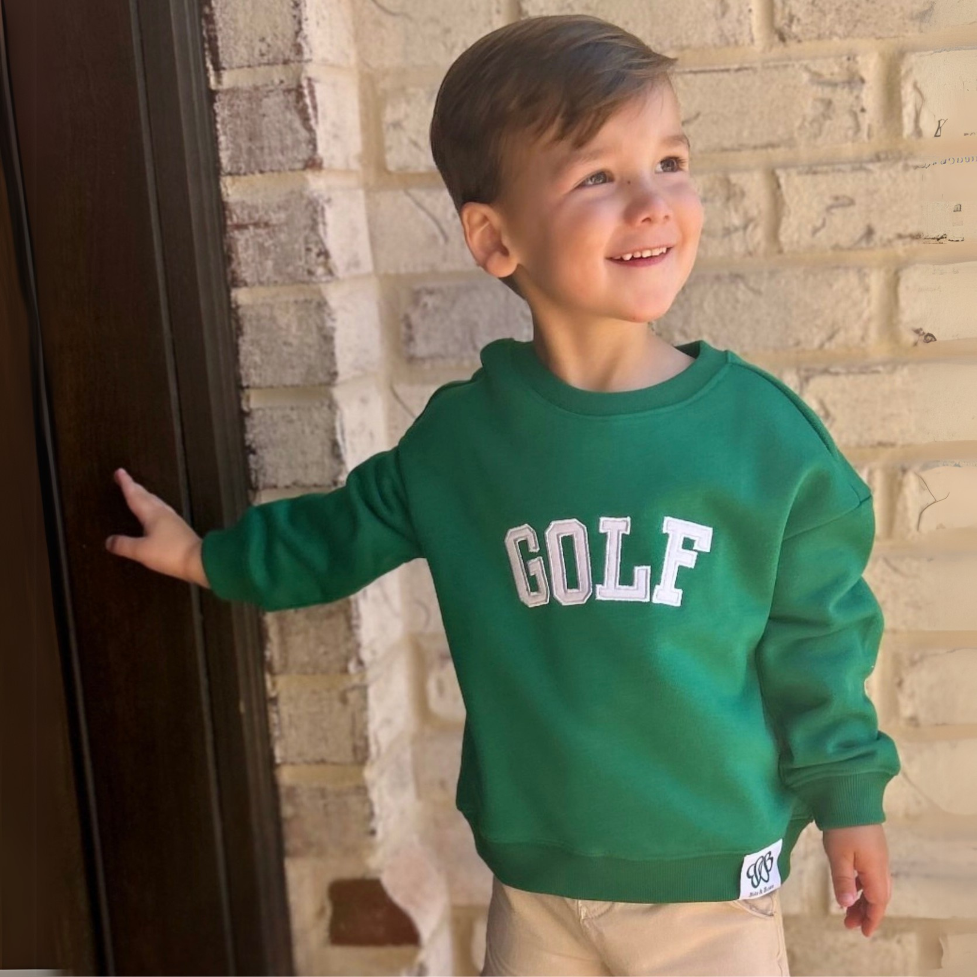 boy wearing green kids golf sweatshirt 