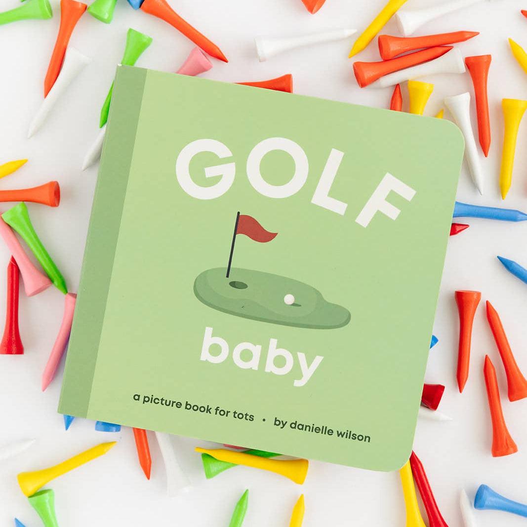 Golf-themed children's book surrounded by colorful golf tees on a white background