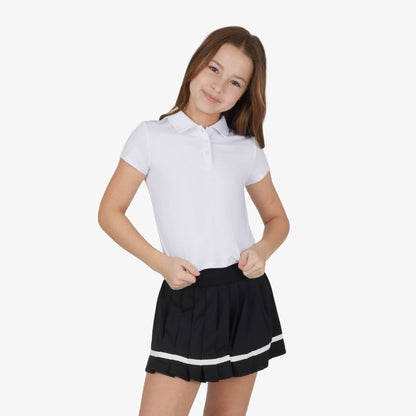 Front view of girls polo top and pleated tennis skort outfit set in white and black