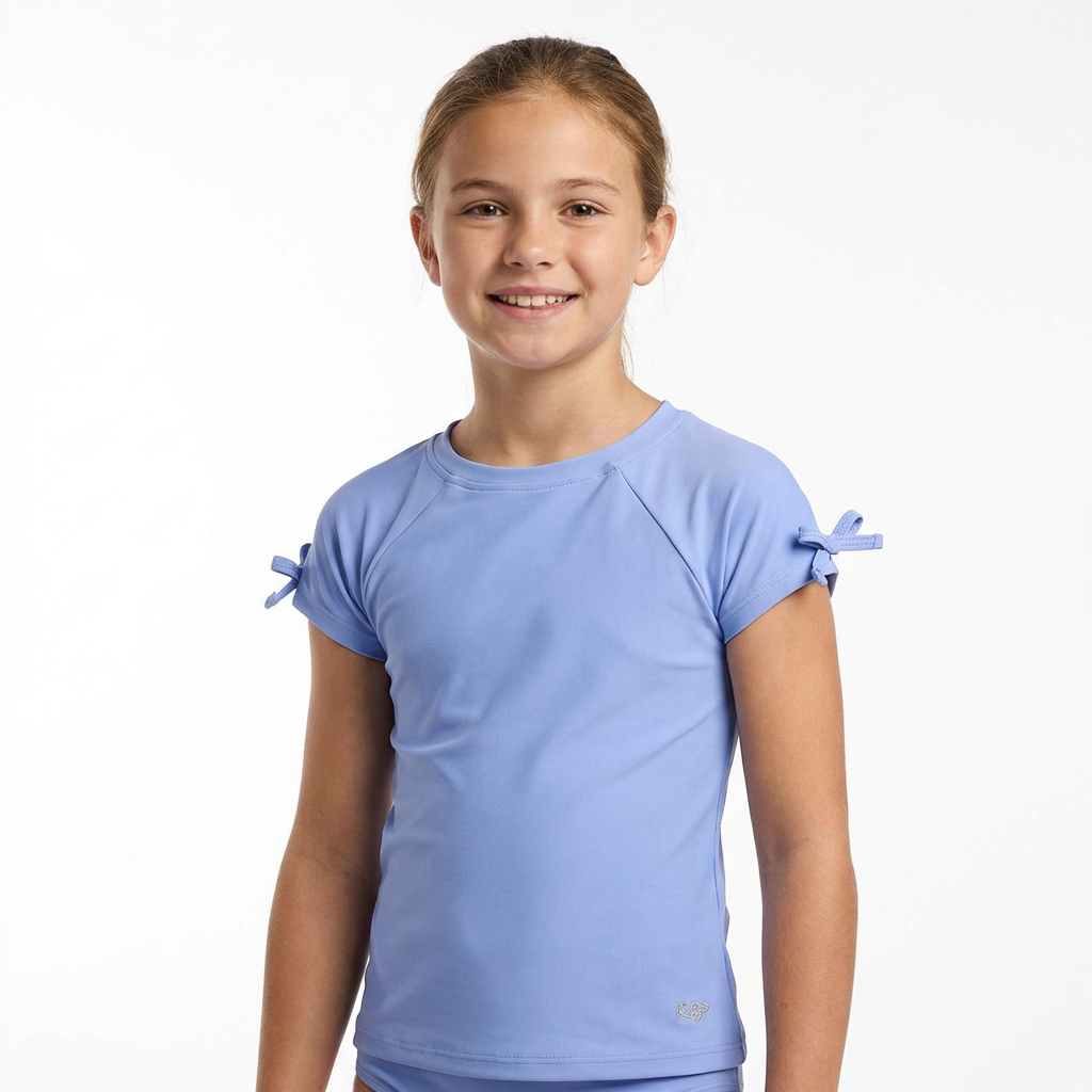 Girl wearing girls performance raglan with bow detail shirt with short sleeves and comfortable athletic fit