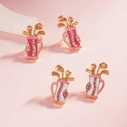 2 sets of earrings featuring golf bags. one set has white golf bags with light pink and gold details. the other set has dark pink bags with light pink and gold details. 