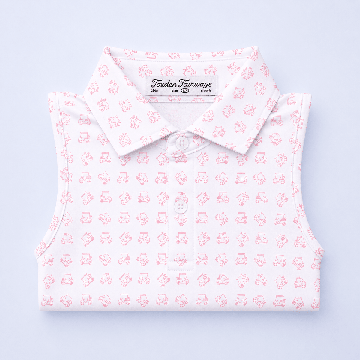 White sleeveless shirt with pink golf cart pattern on a light purple background