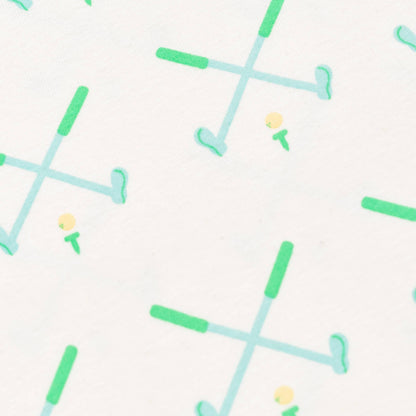 Detail shot of golf pattern. White background, Green and blue golf clubs crossed with yellow golf ball on green tee.