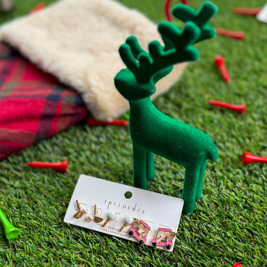 et of golf-themed stud earrings displayed on artificial turf beside a green velvet reindeer and holiday stocking—festive stocking stuffer jewelry for golfers and golf-loving teens.
