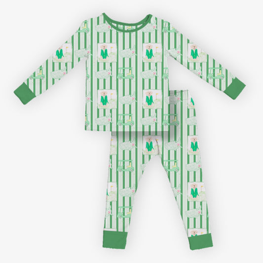 Green kids pajama set with long sleeve top and matching pants featuring golf carts, dogs, and striped pattern