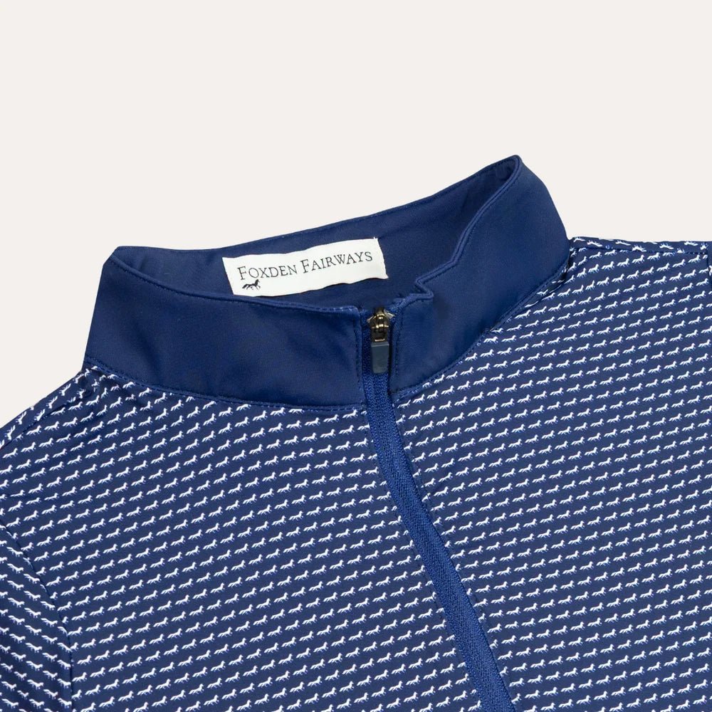 Close-up of a blue and white fox patterned quarter zip with a solid navy collar. The inside collar label reads 'FOXDEN FAIRWAYS'.