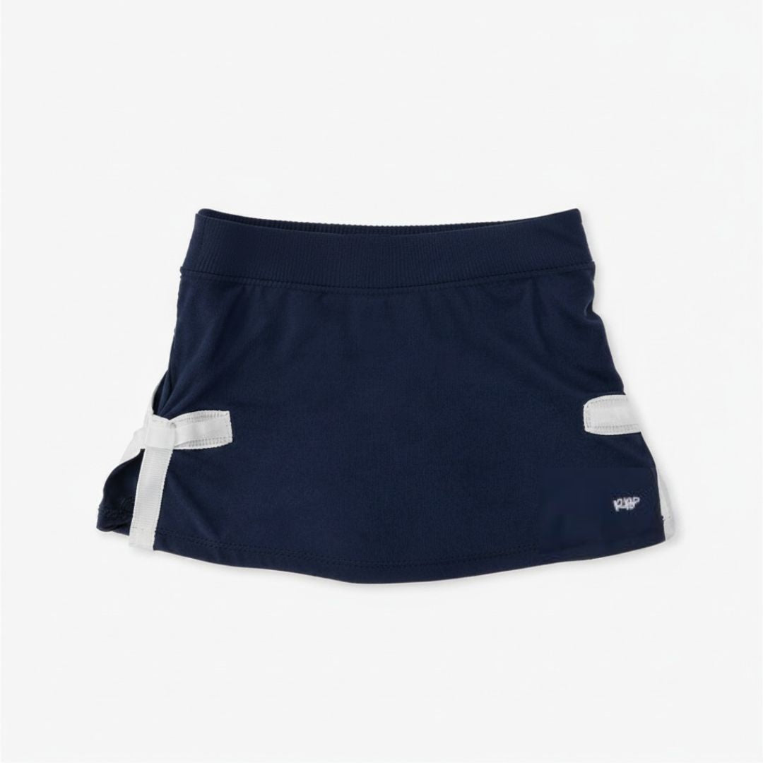 Navy girls athletic skort with white bow detail on white background