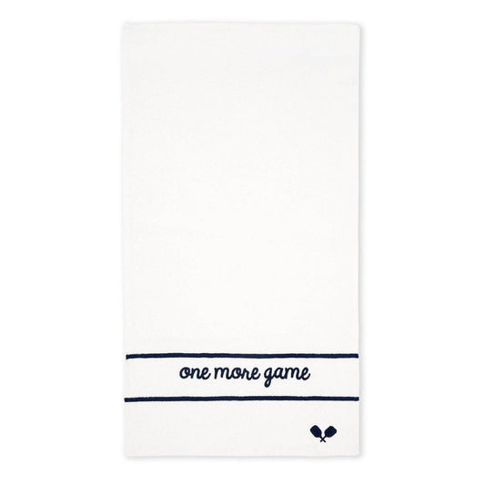 White terry tennis towel with navy embroidered “one more game” text and small crossed racquet icon on a clean background