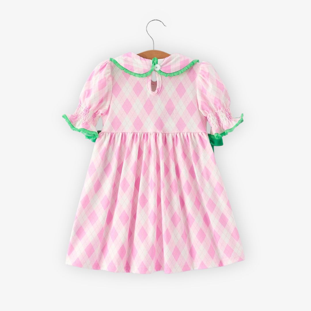 Back view of pink argyle girls dress with smocked sleeves and green trim