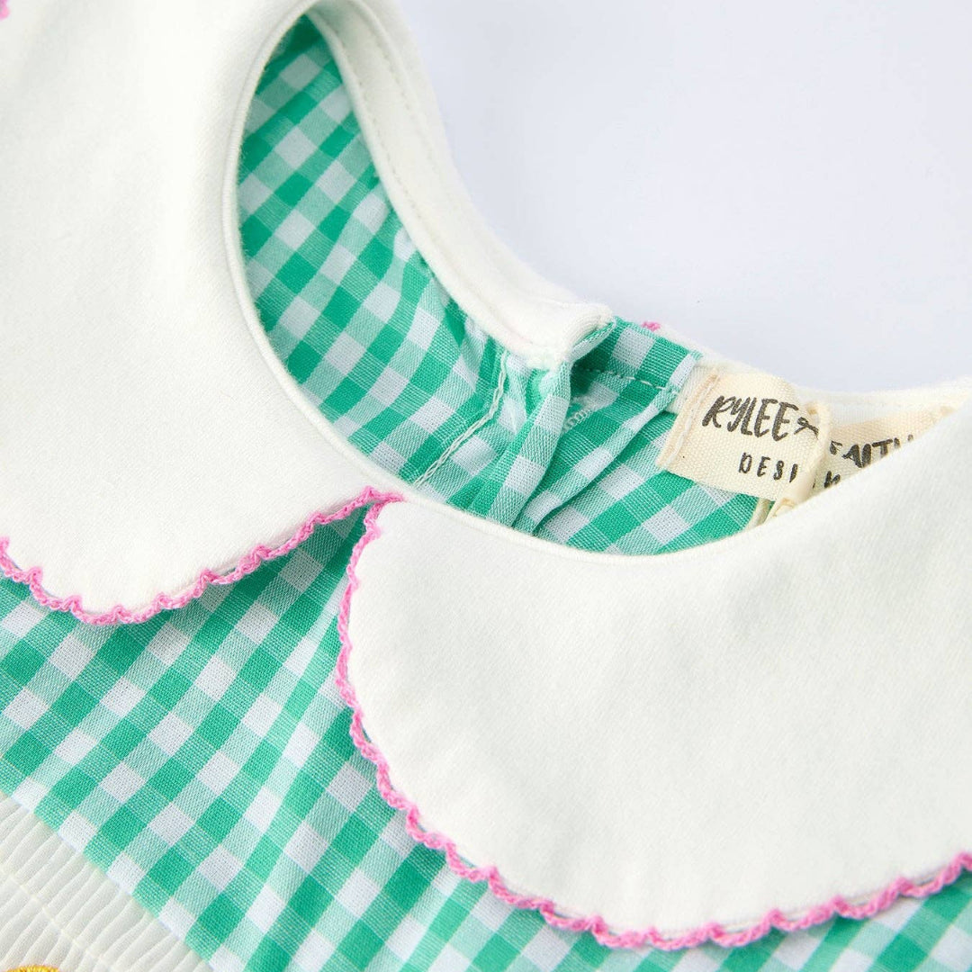 White Peter Pan collar and neckline detail on green gingham girls dress