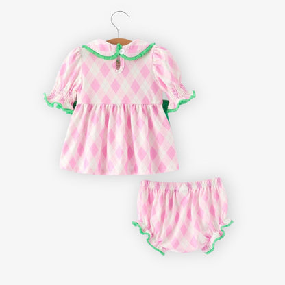Back view of pink argyle baby top with smocked sleeves, green trim, and matching bloomer shorts