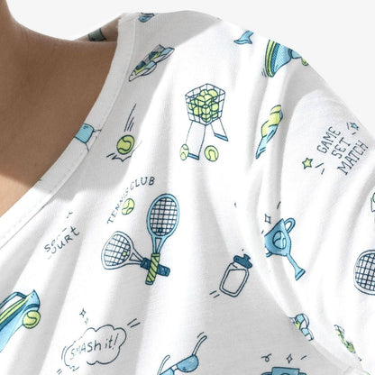White fabric with blue and green tennis-themed patterns, including tennis rackets and balls.